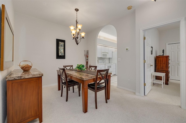 carpeted dining room with a chandelier