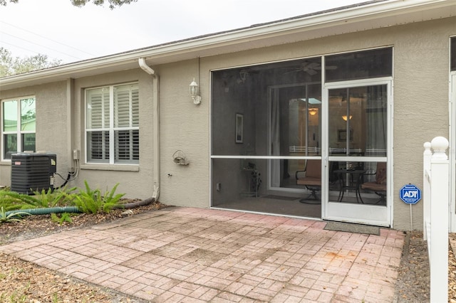 entrance to property featuring cooling unit and a patio