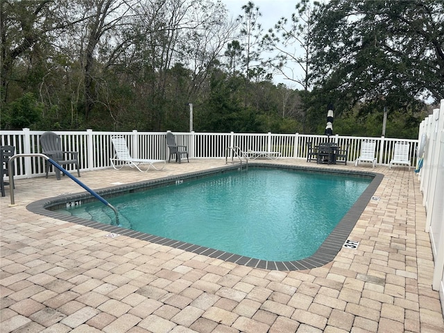 view of swimming pool featuring a patio area