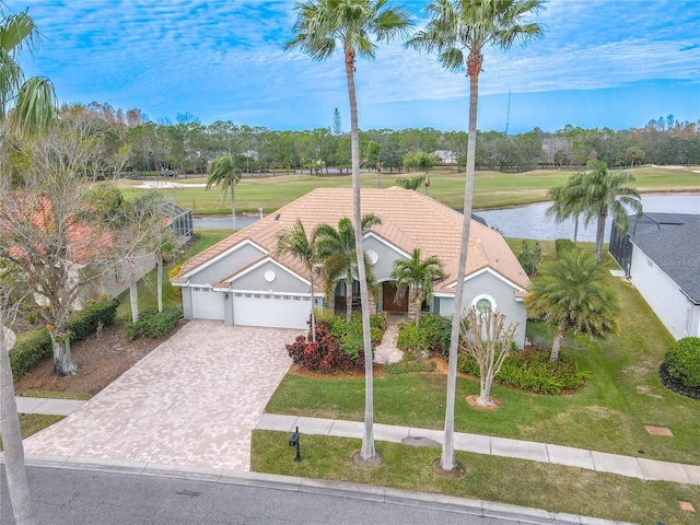 view of front of house featuring a water view, a garage, and a front yard