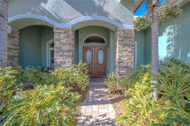 12113 Marblehead Dr, Tampa, FL 33626 - view of exterior entry featuring stucco siding and stone siding