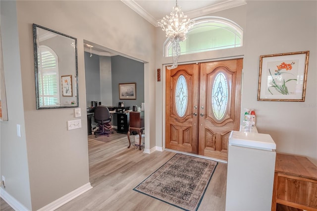 12113 Marblehead Dr, Tampa, FL 33626 - foyer entrance with ornamental molding, healthy amount of natural light, a chandelier, wood finished floors, and baseboards
