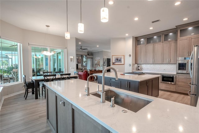 12113 Marblehead Dr, Tampa, FL 33626 - kitchen with light wood-style floors, stainless steel appliances, recessed lighting, backsplash, and light stone counters