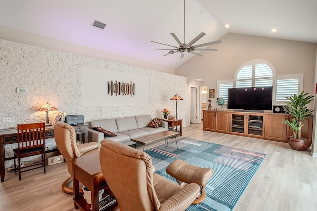 12113 Marblehead Dr, Tampa, FL 33626 - living area featuring arched walkways, a ceiling fan, high vaulted ceiling, and light wood finished floors