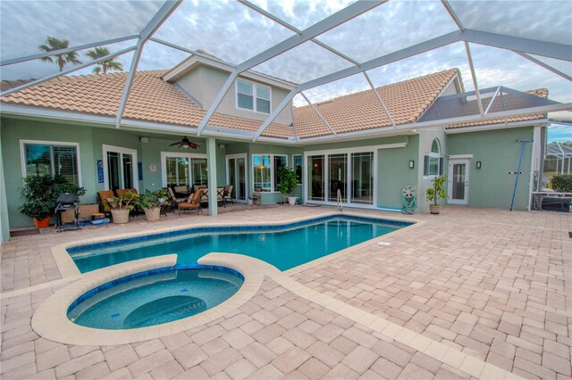 12113 Marblehead Dr, Tampa, FL 33626 - view of swimming pool with a patio area, a ceiling fan, a pool with connected hot tub, and glass enclosure