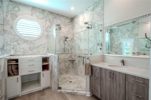 12113 Marblehead Dr, Tampa, FL 33626 - full bathroom with a marble finish shower, vanity, and wood finished floors