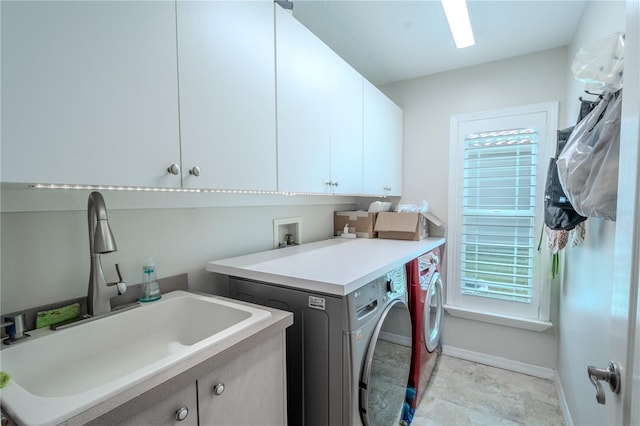 12113 Marblehead Dr, Tampa, FL 33626 - washroom featuring cabinet space, washer and dryer, and baseboards