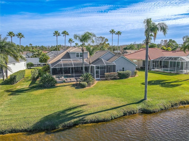 12113 Marblehead Dr, Tampa, FL 33626 - back of property featuring a lawn, a water view, a tiled roof, glass enclosure, and stucco siding