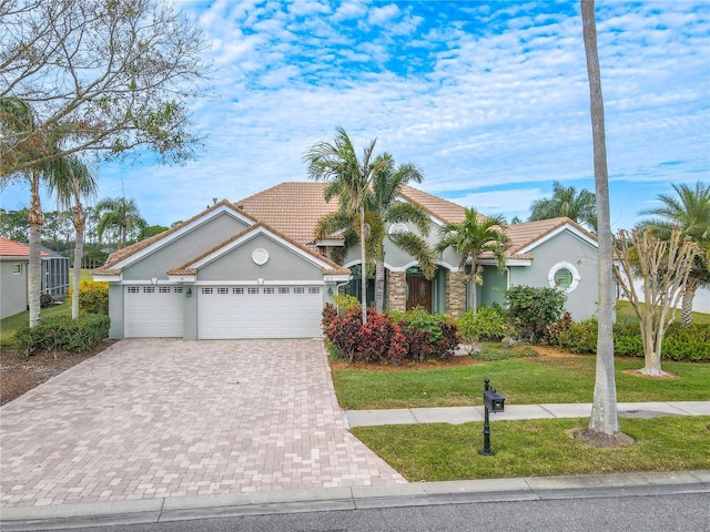 12113 Marblehead Dr, Tampa, FL 33626 - view of front facade with decorative driveway, a front yard, an attached garage, and a tiled roof