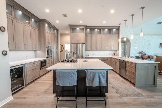 12113 Marblehead Dr, Tampa, FL 33626 - kitchen featuring stainless steel appliances, a peninsula, beverage cooler, decorative backsplash, and recessed lighting