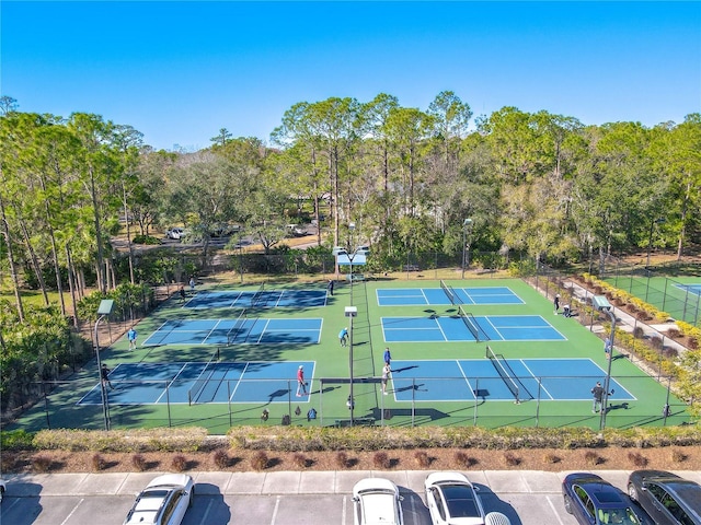 12113 Marblehead Dr, Tampa, FL 33626 - view of tennis court with fence and view of wooded area