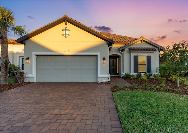 mediterranean / spanish-style house with a garage