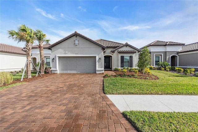 mediterranean / spanish home with a garage and a front yard