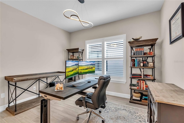 office with light hardwood / wood-style flooring