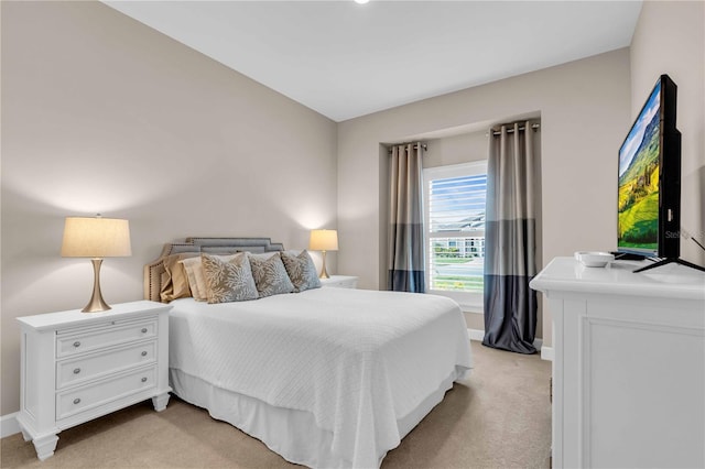 bedroom featuring light carpet