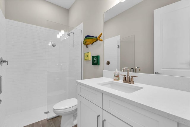 bathroom featuring vanity, toilet, wood-type flooring, and walk in shower