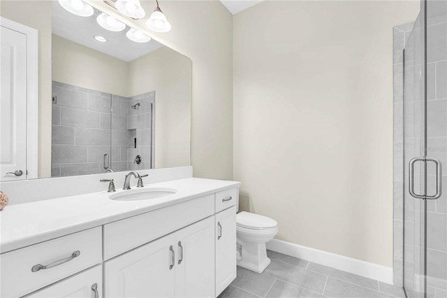 bathroom with tile patterned flooring, vanity, toilet, and a shower with shower door