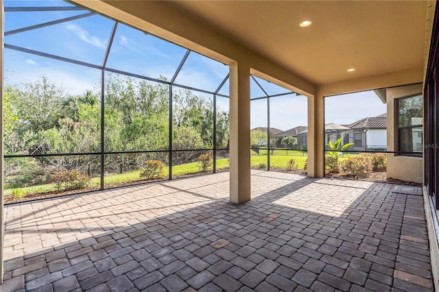 view of patio with glass enclosure