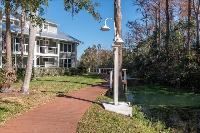 view of home's community featuring a yard and a water view