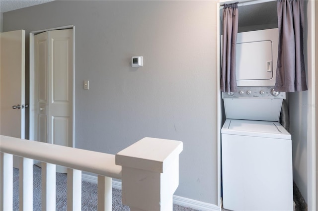 laundry area featuring stacked washing maching and dryer