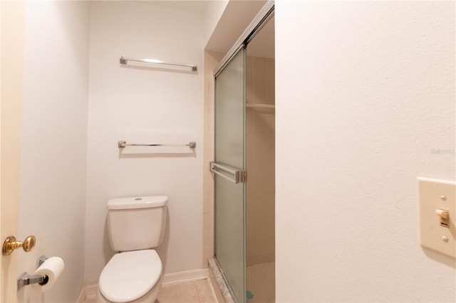 bathroom with a shower with shower door and toilet