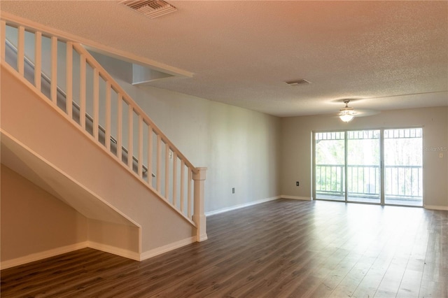 unfurnished living room with ceiling fan, wood-type flooring, and a textured ceiling