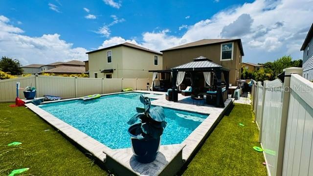 view of swimming pool featuring a gazebo and a yard