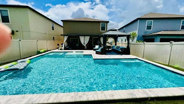 view of swimming pool with a gazebo and an outdoor living space