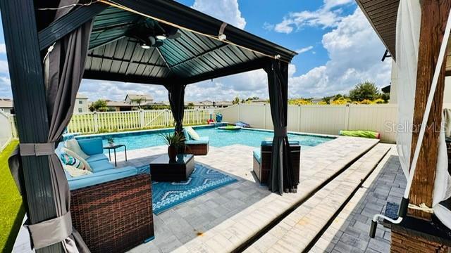 view of swimming pool with a gazebo and a patio area