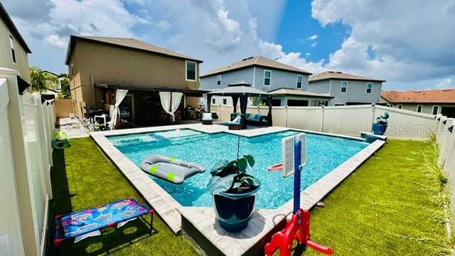 view of pool featuring a gazebo and a yard