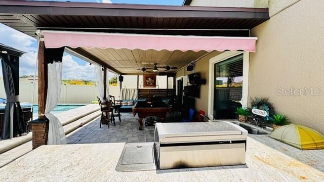 view of patio / terrace with an outdoor kitchen and ceiling fan