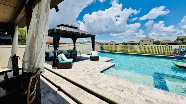 view of swimming pool featuring a gazebo, a patio area, and an outdoor living space