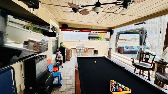 recreation room with ceiling fan, a healthy amount of sunlight, wooden ceiling, and pool table