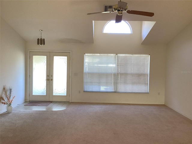 carpeted foyer with ceiling fan, lofted ceiling, and french doors