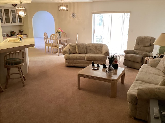 carpeted living room featuring sink