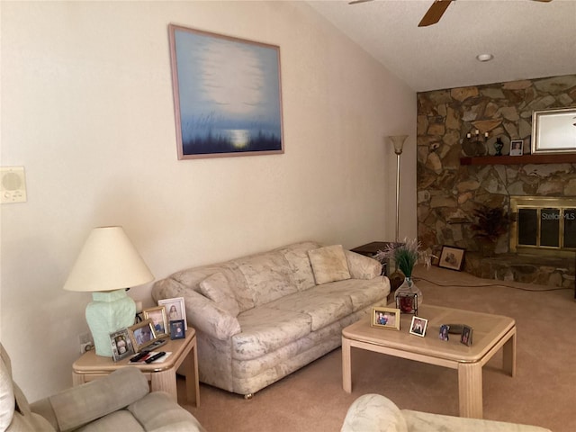 living room with a fireplace, carpet flooring, vaulted ceiling, and ceiling fan