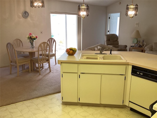 kitchen featuring sink, white dishwasher, pendant lighting, and light colored carpet