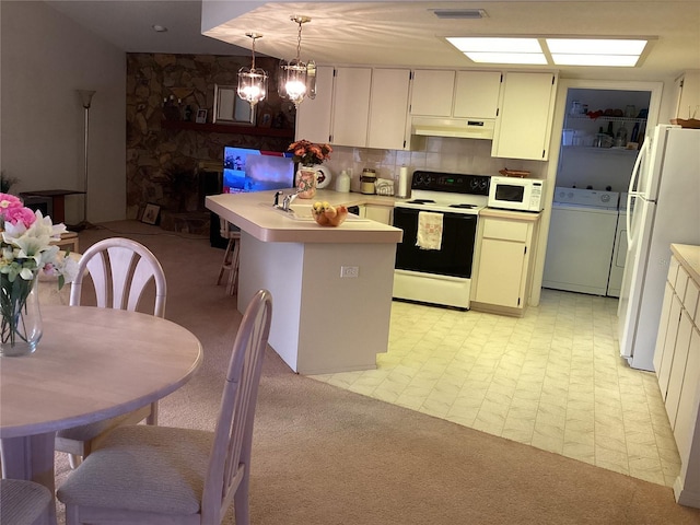 kitchen featuring pendant lighting, white appliances, an inviting chandelier, sink, and washer / clothes dryer