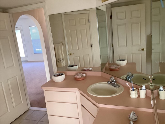 bathroom with tile patterned flooring and vanity