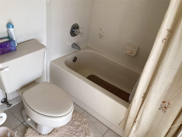 bathroom featuring tile patterned flooring, toilet, and shower / bath combo with shower curtain