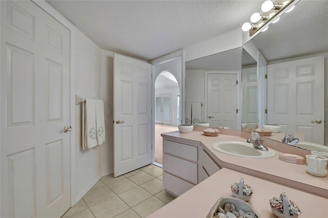 10412 Ireland St, Spring Hill, FL 34608 - bathroom featuring a textured ceiling, tile patterned flooring, and vanity