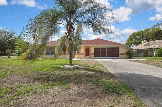10412 Ireland St, Spring Hill, FL 34608 - single story home featuring fence, an attached garage, stucco siding, a front yard, and driveway