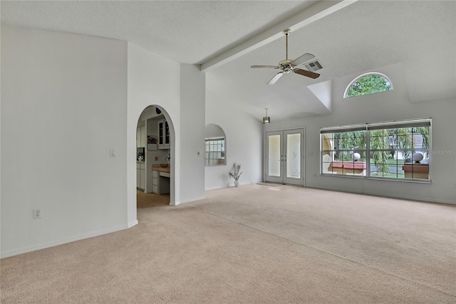 10412 Ireland St, Spring Hill, FL 34608 - unfurnished living room featuring arched walkways, carpet flooring, ceiling fan, and visible vents