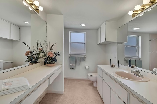 10412 Ireland St, Spring Hill, FL 34608 - bathroom with baseboards, recessed lighting, toilet, and vanity
