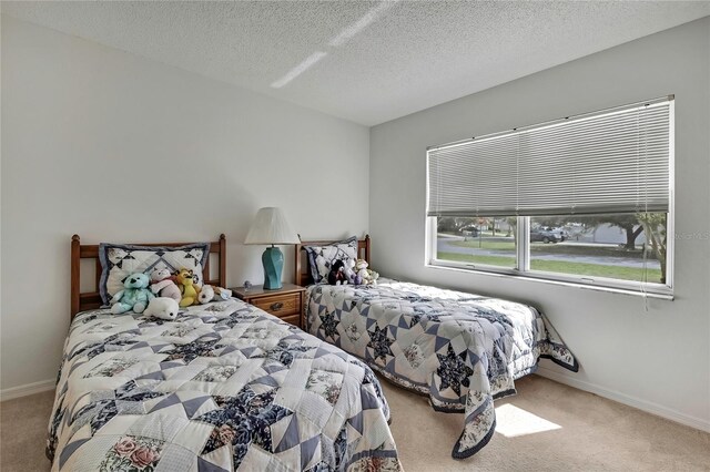 10412 Ireland St, Spring Hill, FL 34608 - bedroom featuring baseboards, carpet, and a textured ceiling