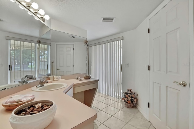 10412 Ireland St, Spring Hill, FL 34608 - bathroom with tile patterned floors, visible vents, and vanity