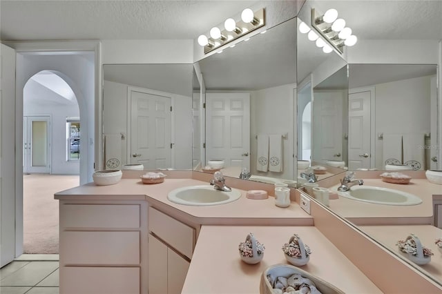 10412 Ireland St, Spring Hill, FL 34608 - bathroom with tile patterned flooring, vanity, and a textured ceiling