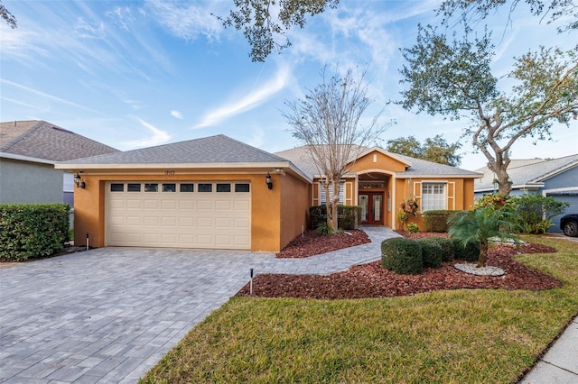 ranch-style house featuring a front lawn and a garage