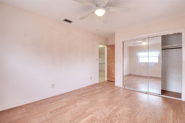 unfurnished bedroom featuring ceiling fan, a closet, and light hardwood / wood-style flooring