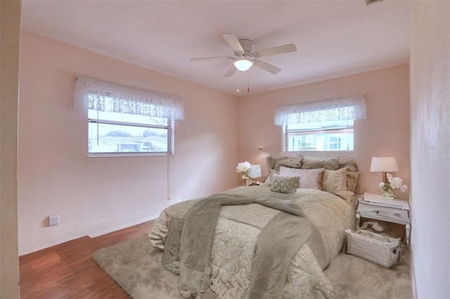 bedroom with wood-type flooring and ceiling fan